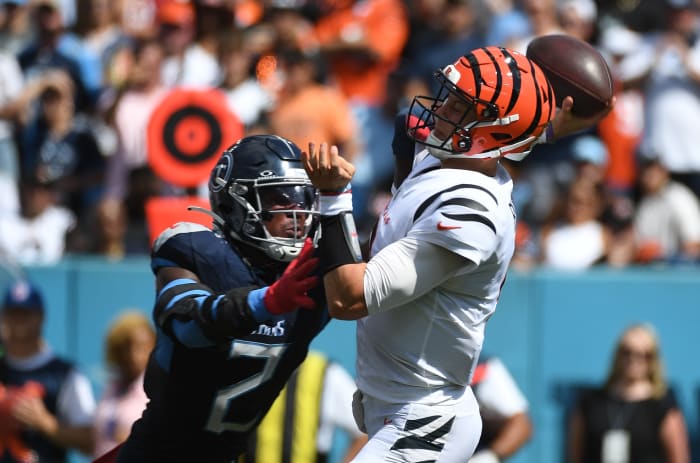 Bengals quarterback Joe Burrow (9) is hit by Tennessee Titans linebacker Azeez Al-Shaair (2) as he throws the ball during the first half at Nissan Stadium.